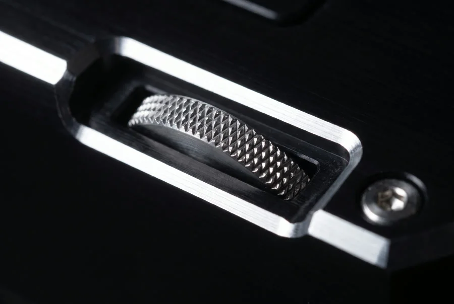 Knurled thumbwheel recessed into the machined chamfer